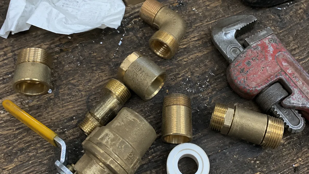 Close view of brass plumbing fittings arranged on a workbench